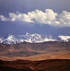 Afghanistan, Hindu Kush Mountains. Rolling foothills and the Hindu Kush Mountain Range near Bamiam, Afghanistan.