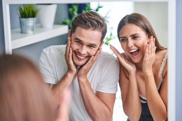 Portrait of happy young couple cuddling in the bathroom