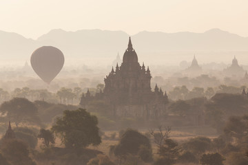 View of the pagodas and temples of the ancient ruined city of Bagan (Pagan), and balloons at...