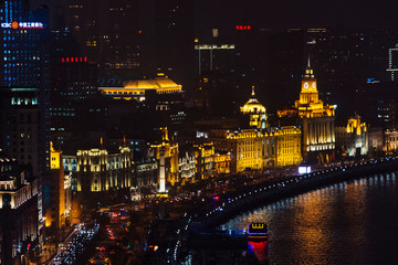Fototapeta na wymiar Night view of colonial buildings along the Bund by Huangpu River, Shanghai, China