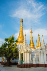 Fototapeta na wymiar Myanmar. Yangon. Shwedagon Pagoda. Stupas near the Northern gate.