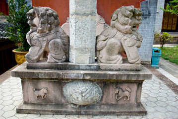 Fototapeta na wymiar Asia, China, Yunnan Province, Mojiang. Sculpture on gate support at Confucious temple includes lions and zodiac animal symbols