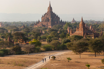 Cyclists and ancient temple city of Bagan (also Pagan), Myanmar (Burma)