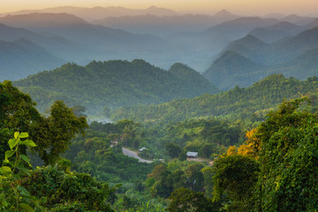 Myanmar. Shan State. Near Kalaw. Sunset over the ridges of haze-filled hills.