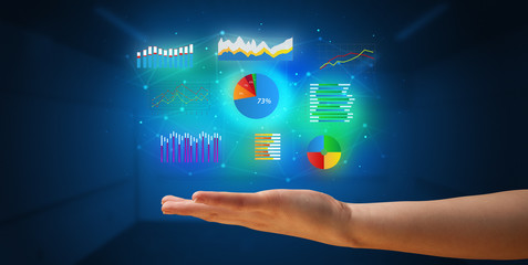 Hand holding diagrams and resultus in his hand, profitable business concept