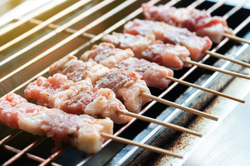 Premium fresh raw beef stick on eletronic stove grill to barbecue.  Roasted beef stick  preparing for meal.