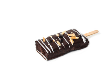 Sweet dark brownie stick with almond slice and white chocolate strips isolaed on white background.