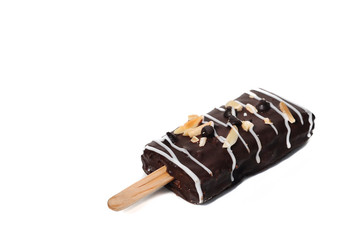 Sweet dark brownie stick with almond slice and white chocolate strips isolaed on white background.