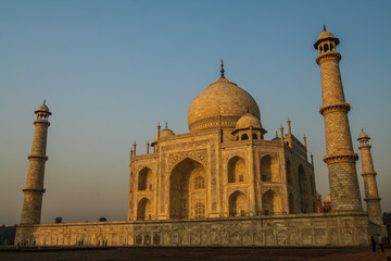 Agra, Rajasthan, India. Taj Mahal and its minarets bask in the glow of morning sunlight and visitors