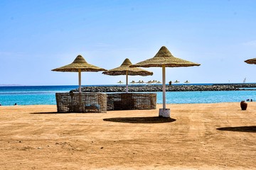 beach with chairs and umbrellas