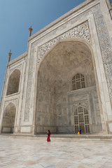 Obraz premium Indie, Agra, Taj Mahal. Słynny pomnik królowej Mumtaz Mahal, około 1632 r. Na liście światowego dziedzictwa UNESCO. Turystka kobieta w tradycyjnym stroju przed Taj Mahal. Tylko do redakcji.