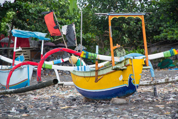 Fototapeta na wymiar Indonesia, Bali. fishing boat along the Bali coast, resting on shore.