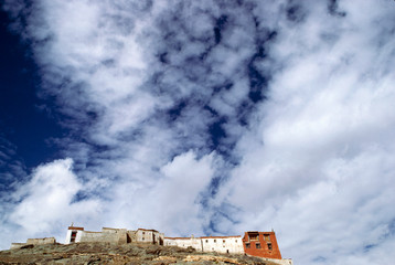 Asia, India, Ladakh, Rangdom. Under a sky mottled with bright clouds, sits the monastery of Rangdom Gompa, Zanskar Valley, India.
