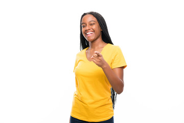 African American teenager girl with long braided hair over isolated white background points finger at you