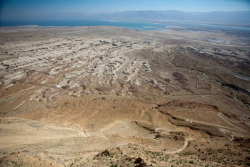 Fototapeta na wymiar View of barren wilderness beneath Jewish fortress of Mount Masada, Israel.