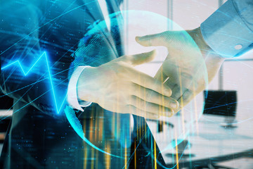 Multi exposure of financial chart and map on office background with two businessmen handshake. Concept of success in business