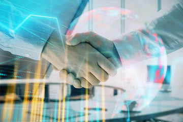 Multi exposure of financial chart and map on office background with two businessmen handshake. Concept of success in business