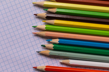  color pencils on a light background to school, beginning  of the school year