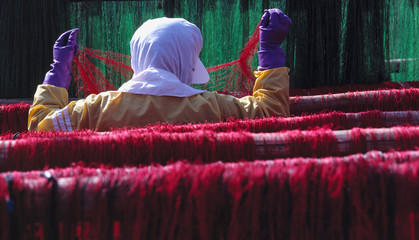 Japan, Mie Pref., Nakiri. A net mender inspects a fishing net for holes in Nakiri, Ise-Shima NP,...
