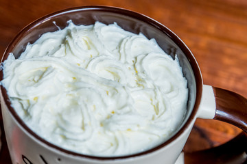 whipped cream in a mug with morning coffee