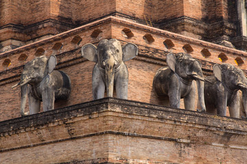 Thailand, Chiang Mai, Wat Chedi Luang. Elephant statues around temple exterior.