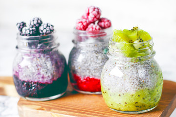 Chia pudding with berries ,raspberry sauce,kiwi sauce,blackberry sauce and frozen raspberries and blackberries and kiwi slices, healthy breakfast, vitamin snack, diet and healthy eating