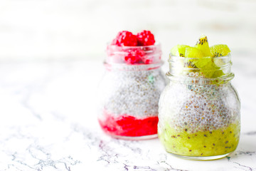 Obraz na płótnie Canvas Chia pudding with berries ,raspberry sauce,kiwi sauce,blackberry sauce and frozen raspberries and blackberries and kiwi slices, healthy breakfast, vitamin snack, diet and healthy eating