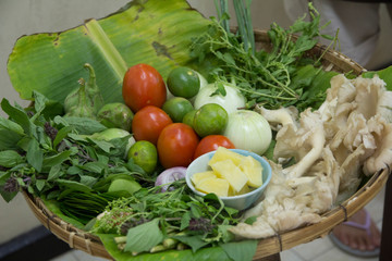 Thailand, Chiang Mai. Thai cooking school, preparing foods with basic ingredients of sprouts, leaves, vegetables and mushrooms plus limes.