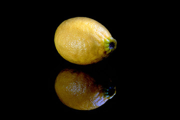 shot of sliced and whole lemons isolated on black background