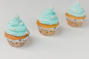 Cupcake decorated with sugar snowflakes and blue cream.Christmas winter cupcakes