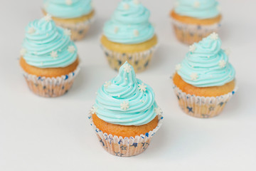 Cupcake decorated with sugar snowflakes and blue cream.Christmas winter cupcakes