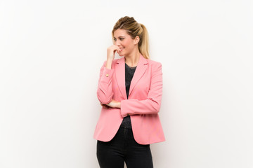 Young blonde woman with pink suit looking to the side