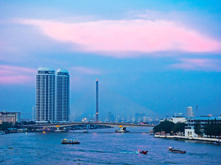 Naklejka premium Southeast Asia, Thailand, Bangkok, Chao Phraya River through city at sunset, Bangkok