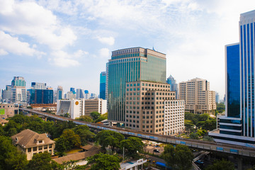 Fototapeta na wymiar Bangkok, Thailand - The downtown buildings of a city and residential area are separated by an elevated roadway.