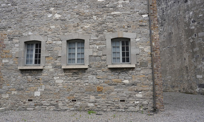 Fototapeta na wymiar Windows on stone Building