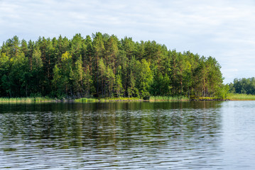Fototapeta na wymiar A calm day on the shores of the calm Saimaa lake in the Linnansaari National Park in Finland - 3
