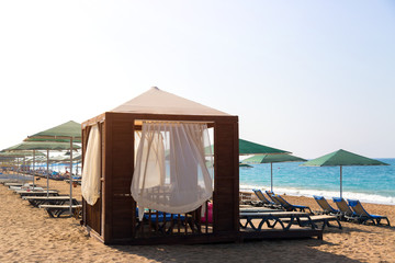 Exclusive beach holiday destination. tent place under a canopy for cozy luxurious holiday by the sea.