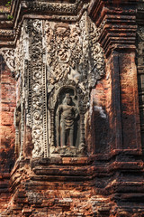Siem Reap, Cambodia. Carved stone guardian protects the ancient ruins and towers of the Bayon Temple in Preah Khan (Roluos Group)