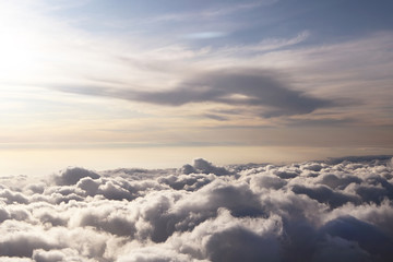 Sky view on the plane. Beautiful sky above clouds with dramatic light in the evening. Cabin view