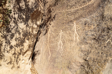 Azerbaijan, Qobustan. Petroglyphs of people carved into a stone at Gobustan National Park.