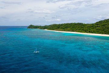 Aerial drone view of the beauiful sandy, tropical beach of Pukka Shell on Boracay Island, Philippines