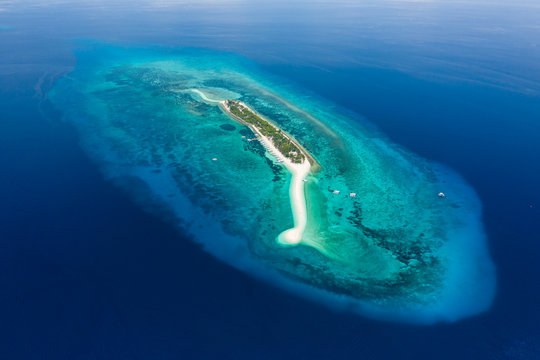 Aerial drone view of a beautiful tropical island with sandy beach surrounded by Coral Reef (Kalanggaman Island, Philippines)