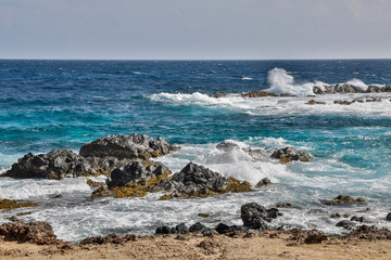 West Indies, Caribbean, Aruba. Andicuri Beach, waves as the tide come in among the rock formations