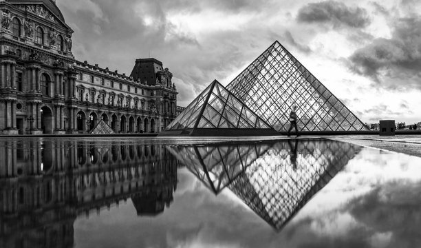 iew of famous Louvre Museum with Louvre Pyramid at evening