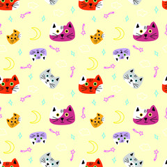 Multicolored, spotted snouts of cats, stars, moon, comets isolated on a light yellow background-seamless vector ornament