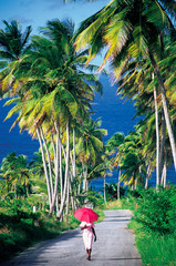 Woman with parasol walking in Barbados