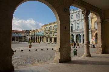 Cuba, Havana, restored Colonial plaza, viewed through arch. Old Havana (La Habana Vieja) is a UNESCO World Heritage Site