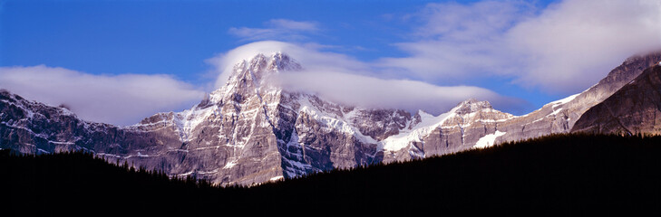 Canada, Alberta, Mt. Chephren. Wind whips the snow off Mt. Chephren in Banff NP, a World Heritage...