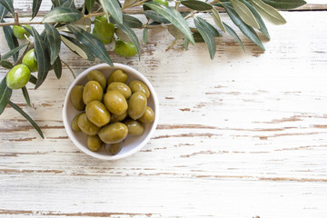 Fresh organic green olives on the white plate,olive branch with green olives,isolated,space for text