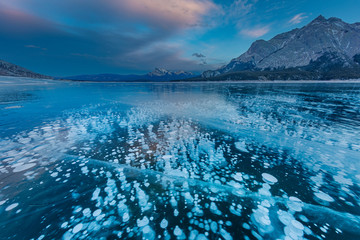 Methane ice bubbles under clear ice on Abraham Lake near Nordegg, Alberta, Canada - obrazy, fototapety, plakaty
